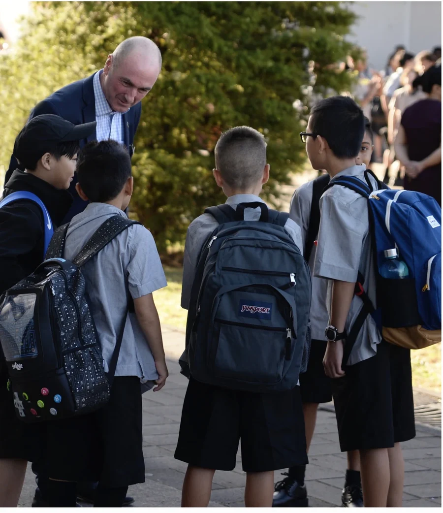 Principal Ian Morrison greeting students